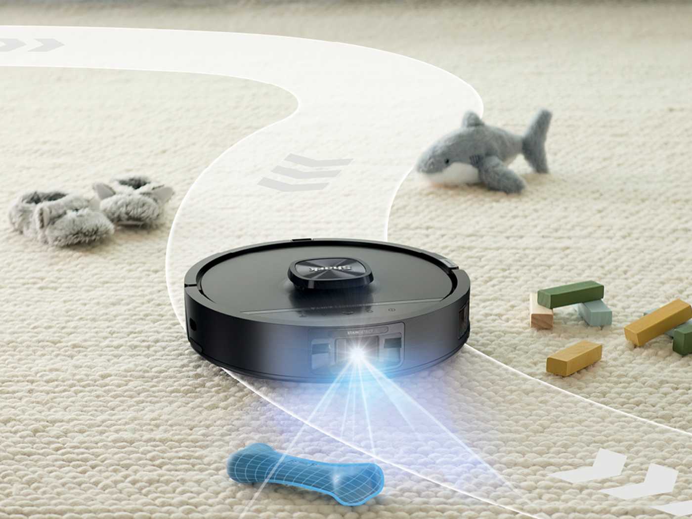 The robot steering around a charging cable and a pair of shoes